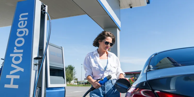 Driver connecting hydrogen refueling nozzle to fuel cell vehicle